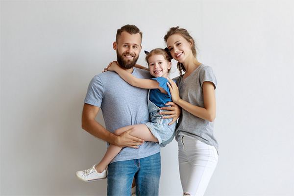 Smiling mother and father with their young child