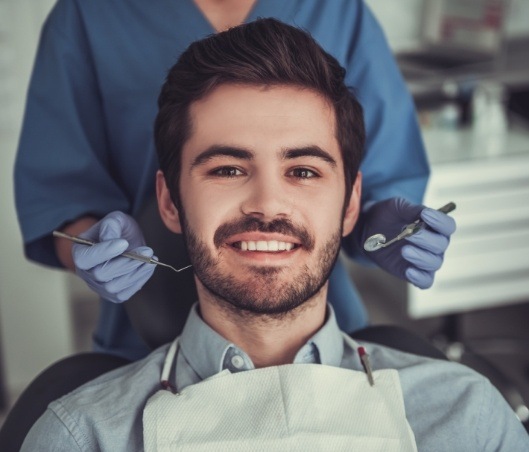 Man in dental chair preparing for dental bone grafts in Fort Worth