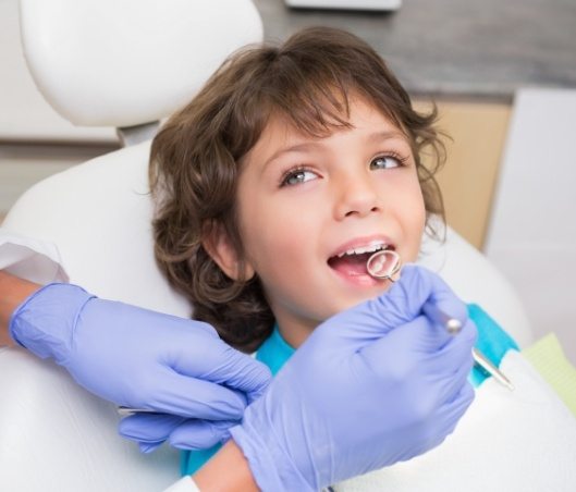 Young boy smiling while visiting a children's dentist in Fort Worth