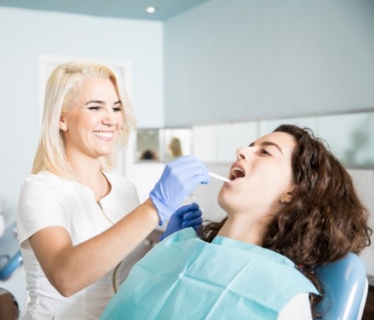 Young woman receiving a comprehensive dental exam in Fort Worth