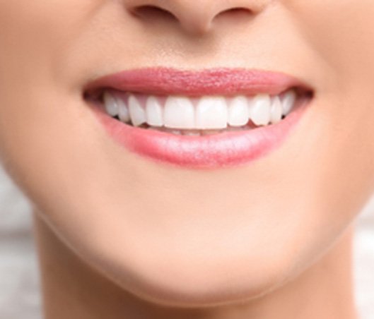 Closeup of woman with white teeth smiling