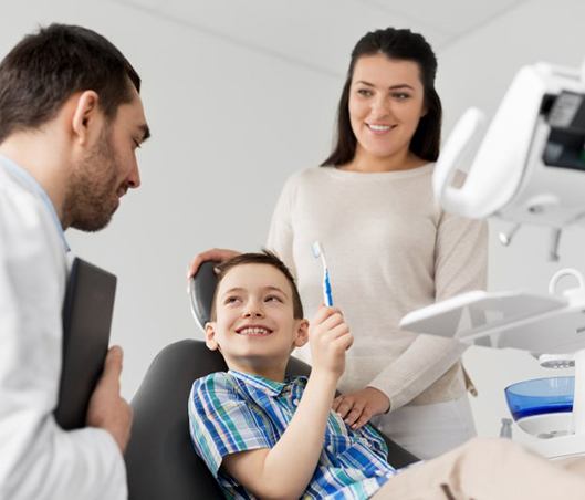 a child patient receiving care from his family dentist