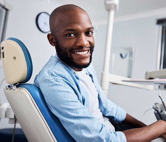 Bearded male patient smiling in dental chair