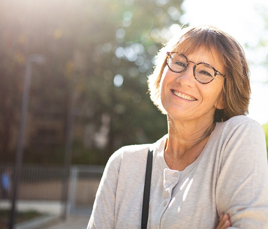 Older woman with glasses smiling