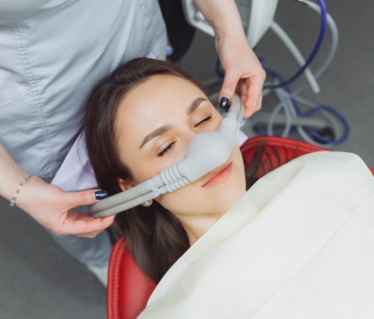 Woman in dental chair wearing nasal mask for sedation dentistry in Fort Worth