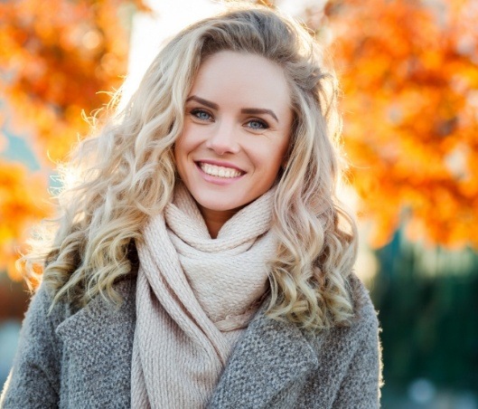 Blond woman grinning outdoors in autumn after SmileFast in Fort Worth