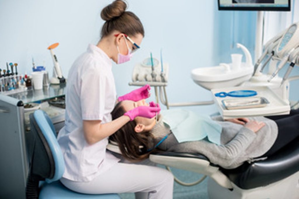 dentist performing checkup on patient
